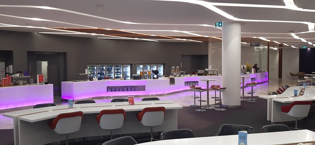Không gian phòng chờ VIP tại sân bay với quầy đồ ăn và chỗ ngồi
